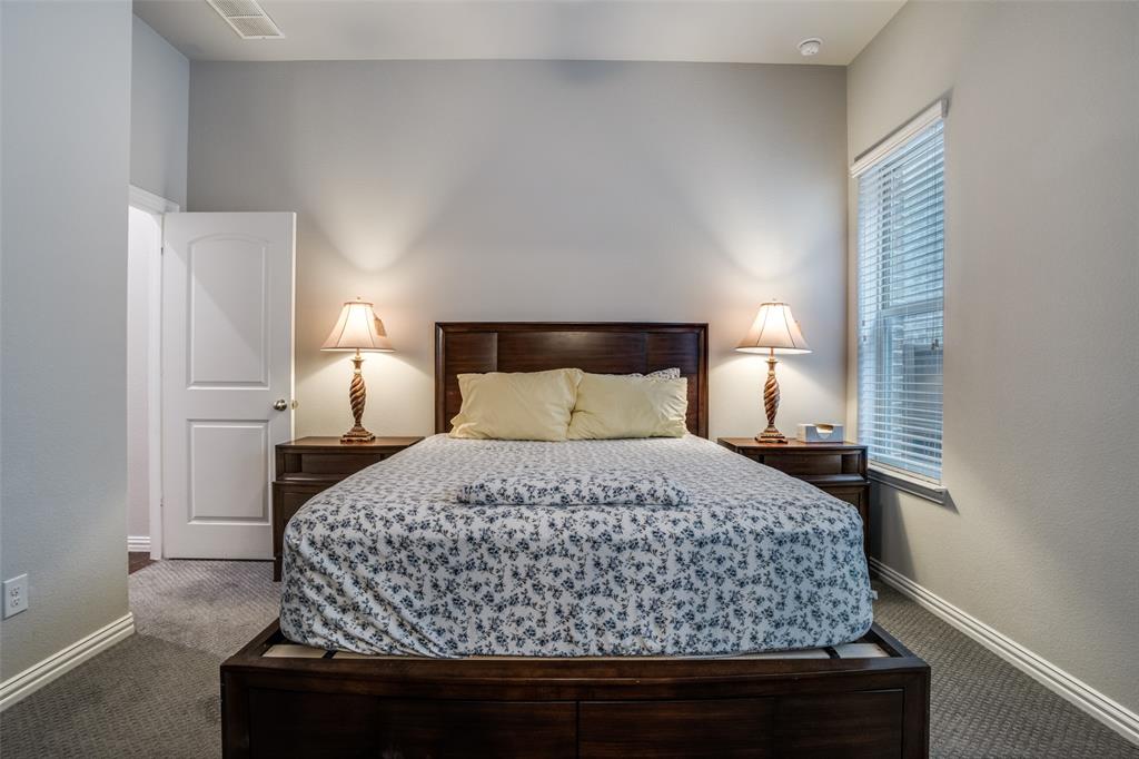 3410 Challis Trail McKinney, TX 75070 - Photo 8 of 31 a bedroom with a bed and a night stand