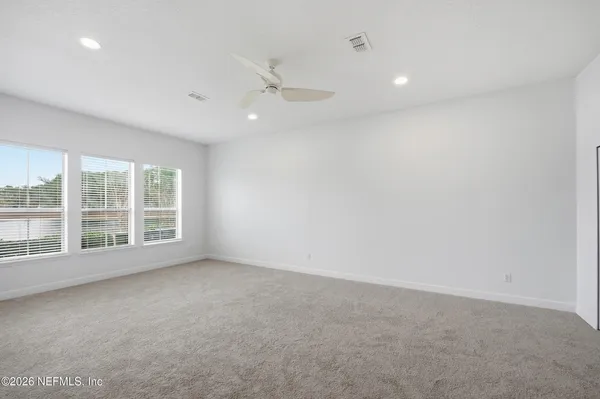 a view of a livingroom with wooden floor and a window