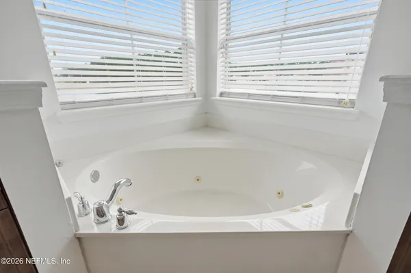 a bathroom with a double vanity sink toilet and a mirror