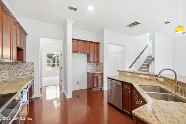 a kitchen with stainless steel appliances granite countertop a sink stove and refrigerator