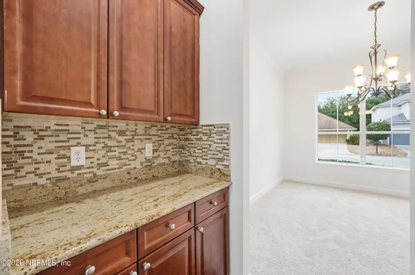 a view of a kitchen with a sink and cabinets