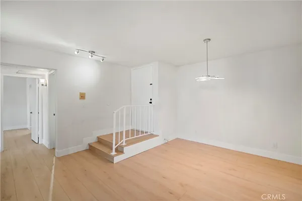 a view of a room with wooden floor