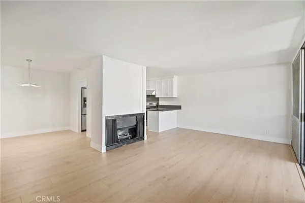 a view of kitchen with refrigerator sink and wooden floor