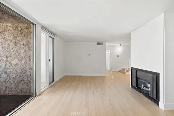 a kitchen with stainless steel appliances granite countertop a stove and white cabinets