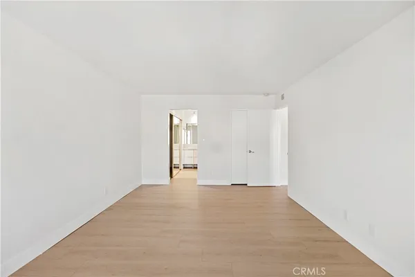 a view of kitchen with refrigerator and window