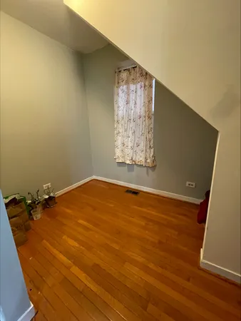 a view of a room with wooden floor and windows