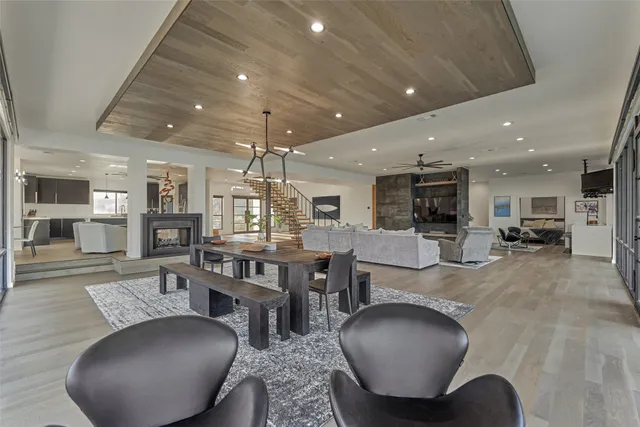 a living room with furniture a wooden floor and chandelier