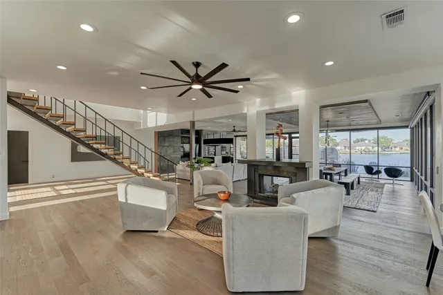 a living room with furniture and view of kitchen