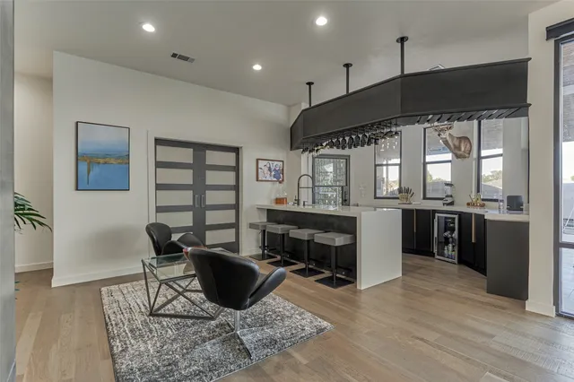 a living room with furniture a large window and a fireplace