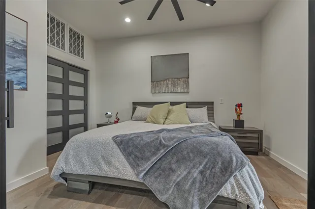 a bedroom with a bed and a painting on the wall