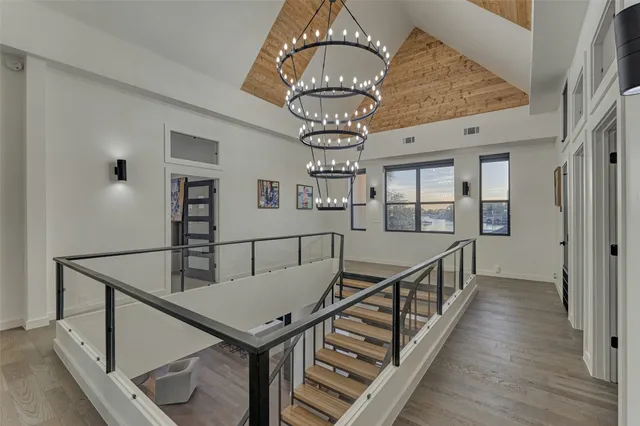 a view of entryway and hall with wooden floor