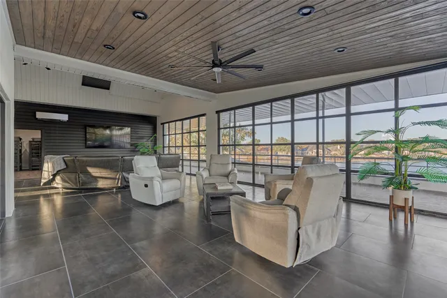 a living room with couches and a dining table with outer view