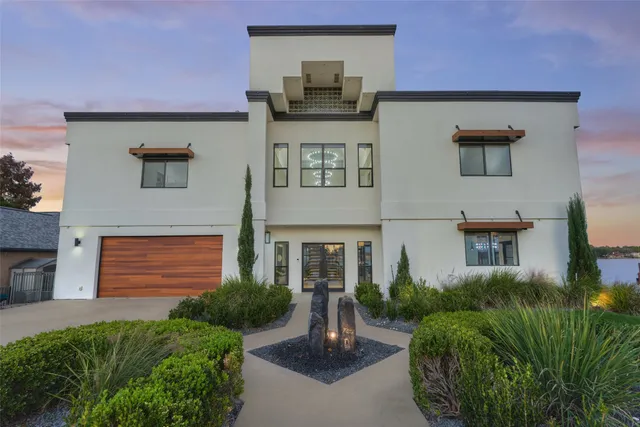 a front view of a house with a garden