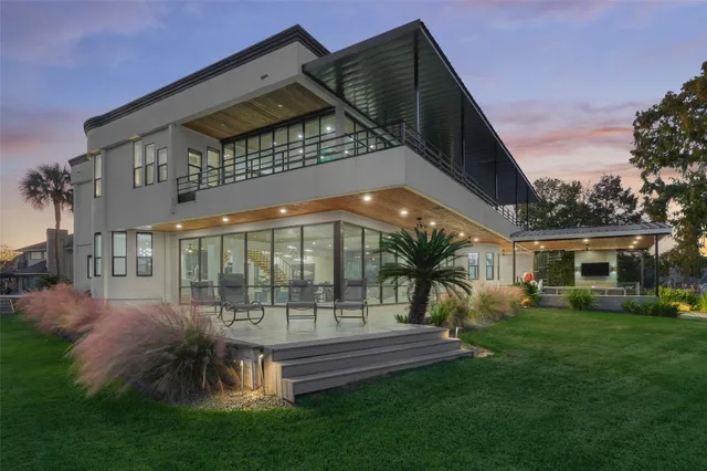 a view of a house with a yard balcony and sitting area