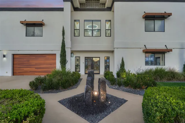 a front view of a house with garden
