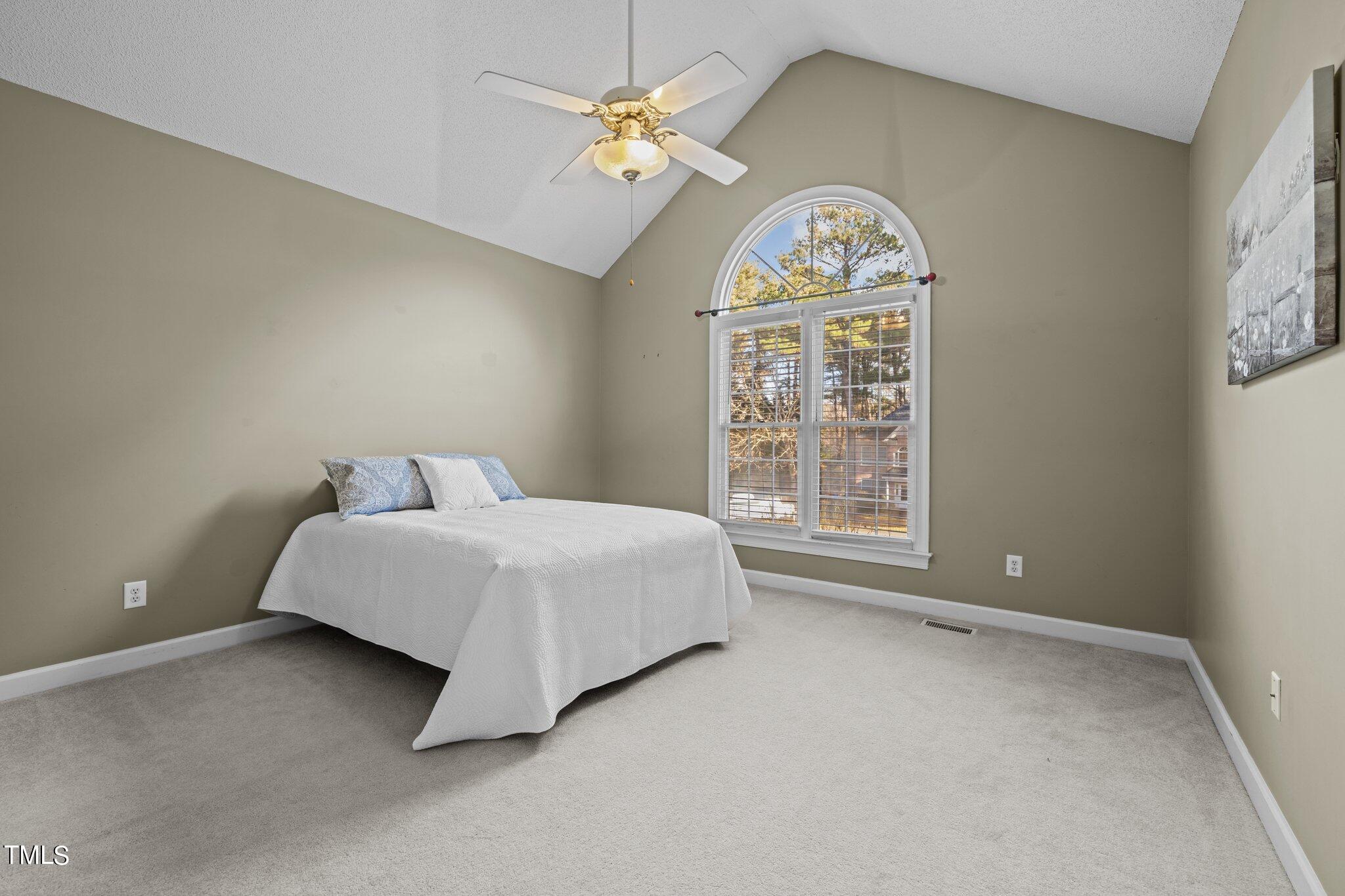 209 Priceview Drive Raleigh, NC 27603 - Photo 12 of 20 a spacious bedroom with a bed and a window