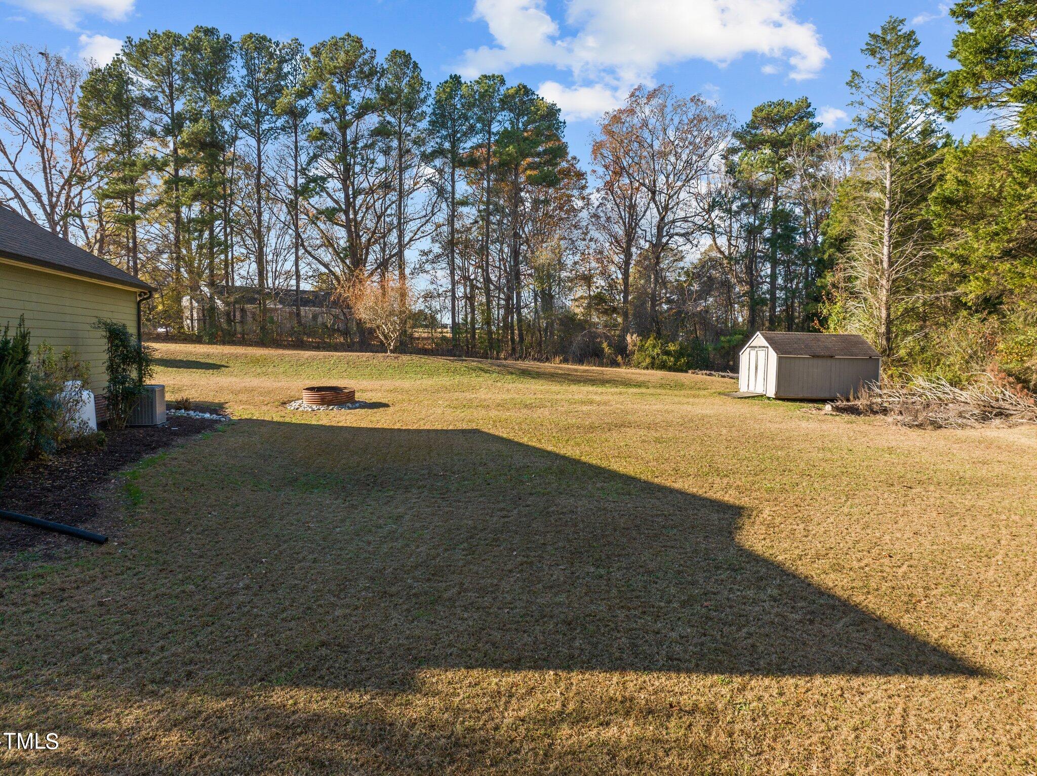 209 Priceview Drive Raleigh, NC 27603 - Photo 18 of 20 a view of a swimming pool with an outdoor space and seating area