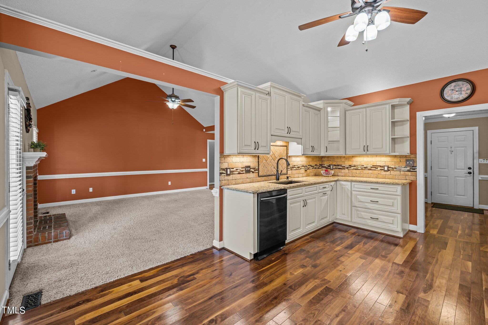 209 Priceview Drive Raleigh, NC 27603 - Photo 5 of 20 a kitchen with a refrigerator stove and white cabinets