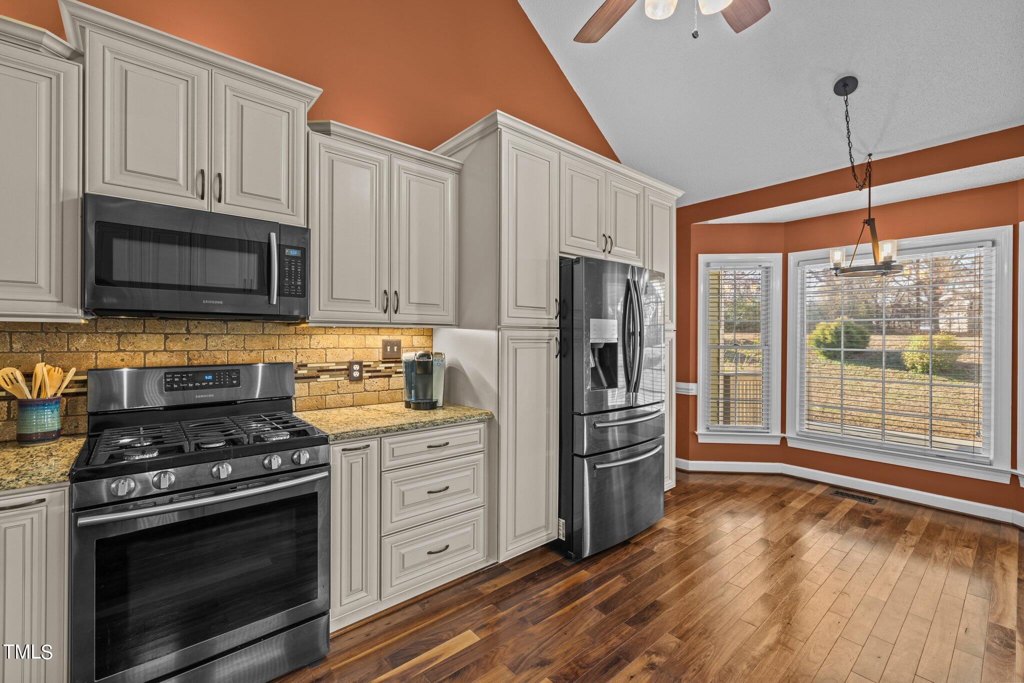 209 Priceview Drive Raleigh, NC 27603 - Photo 7 of 20 a kitchen with granite countertop a refrigerator stove and oven