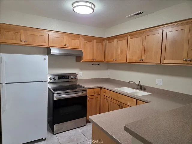 a kitchen with appliances cabinets and a counter top space