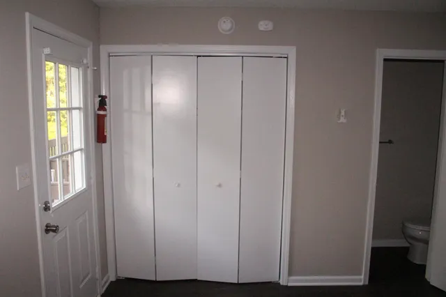 a view of an entryway with wooden floor