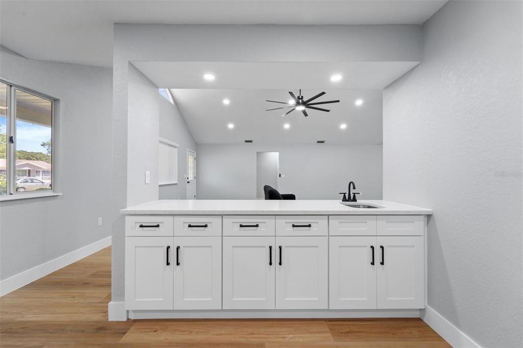 8170 Southwest 109 Street Road Ocala, FL 34481 - Photo 11 of 18 a view of cabinets with wooden floor and window