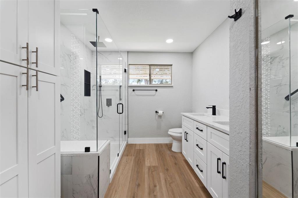 8170 Southwest 109 Street Road Ocala, FL 34481 - Photo 12 of 18 a spacious bathroom with a double vanity sink a toilet and shower