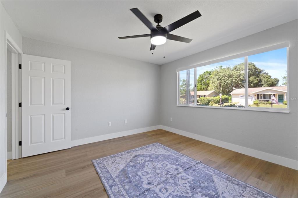 8170 Southwest 109 Street Road Ocala, FL 34481 - Photo 14 of 18 wooden floor in an empty room with a window