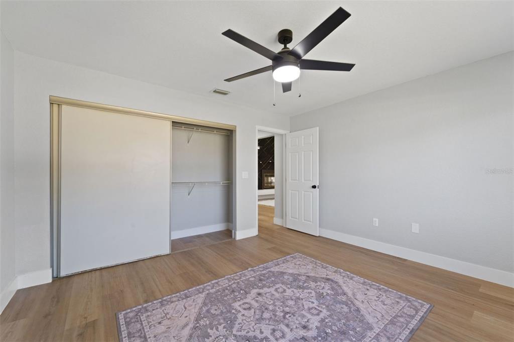 8170 Southwest 109 Street Road Ocala, FL 34481 - Photo 16 of 18 wooden floor in an empty room with a window