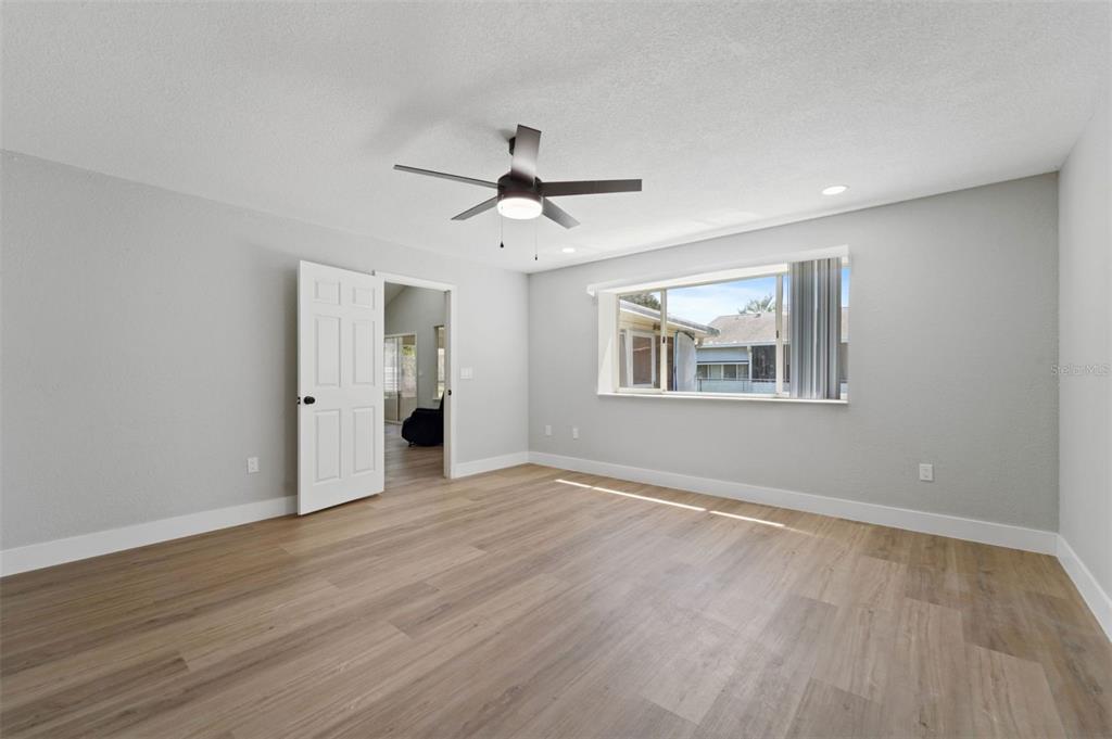 8170 Southwest 109 Street Road Ocala, FL 34481 - Photo 17 of 18 a view of empty room with wooden floor and ceiling fan