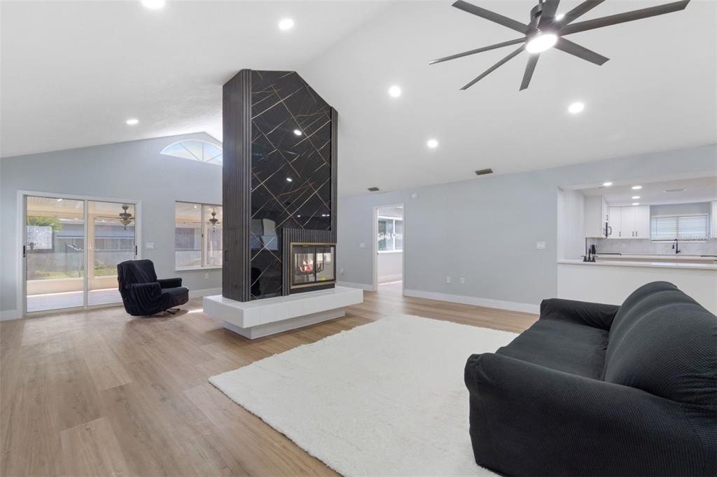 8170 Southwest 109 Street Road Ocala, FL 34481 - Photo 7 of 18 a living room with furniture ceiling fan and a wooden floor