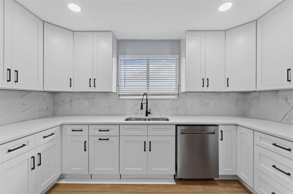 8170 Southwest 109 Street Road Ocala, FL 34481 - Photo 9 of 18 a kitchen with white cabinets and white appliances