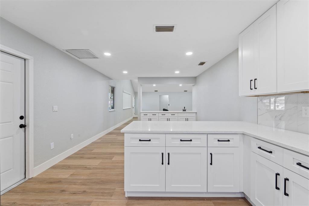 8170 Southwest 109 Street Road Ocala, FL 34481 - Photo 10 of 18 a view of kitchen with stainless steel appliances cabinets and wooden floor