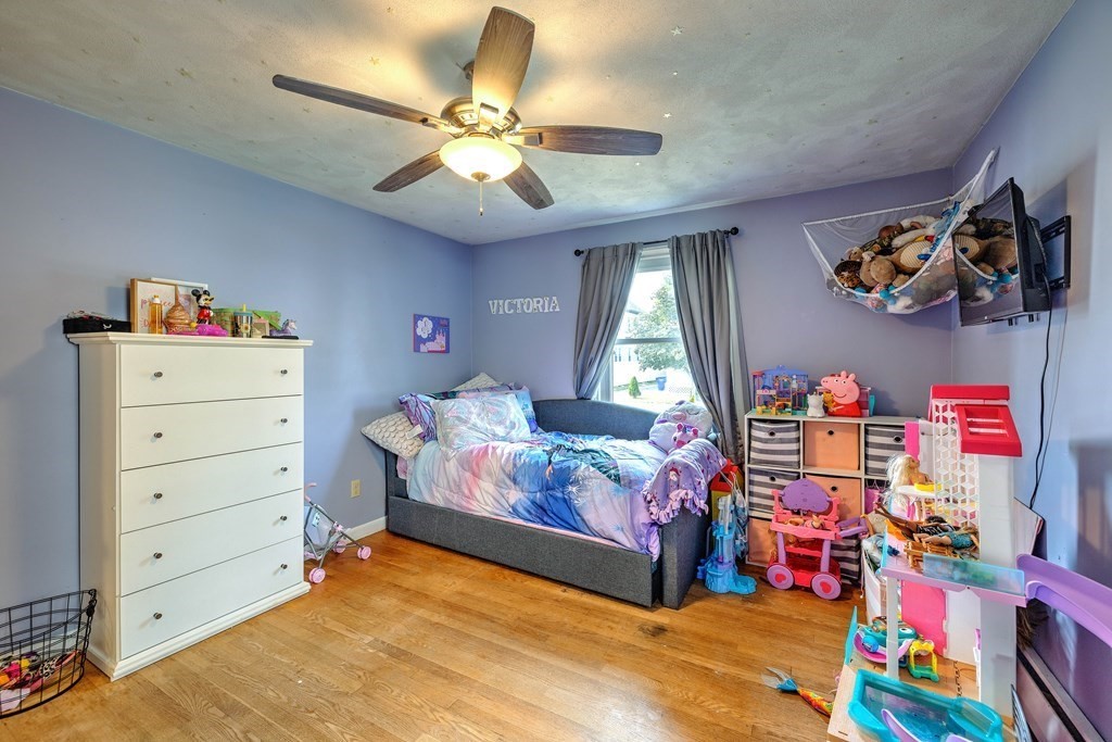 41 Shawmut Street Springfield, MA 01108 - Photo 21 of 39 a bedroom with a bed and a chandelier