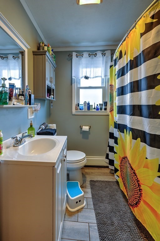 41 Shawmut Street Springfield, MA 01108 - Photo 25 of 39 a bathroom with a sink a toilet and mirror