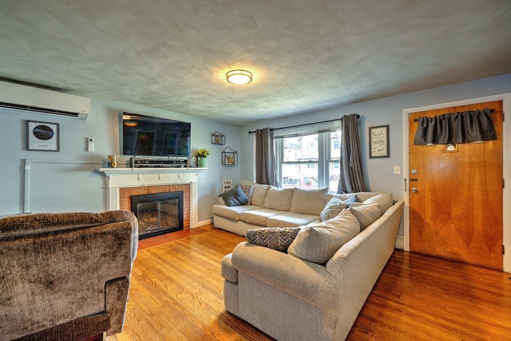 41 Shawmut Street Springfield, MA 01108 - Photo 10 of 39 a living room with furniture a fireplace and a flat screen tv