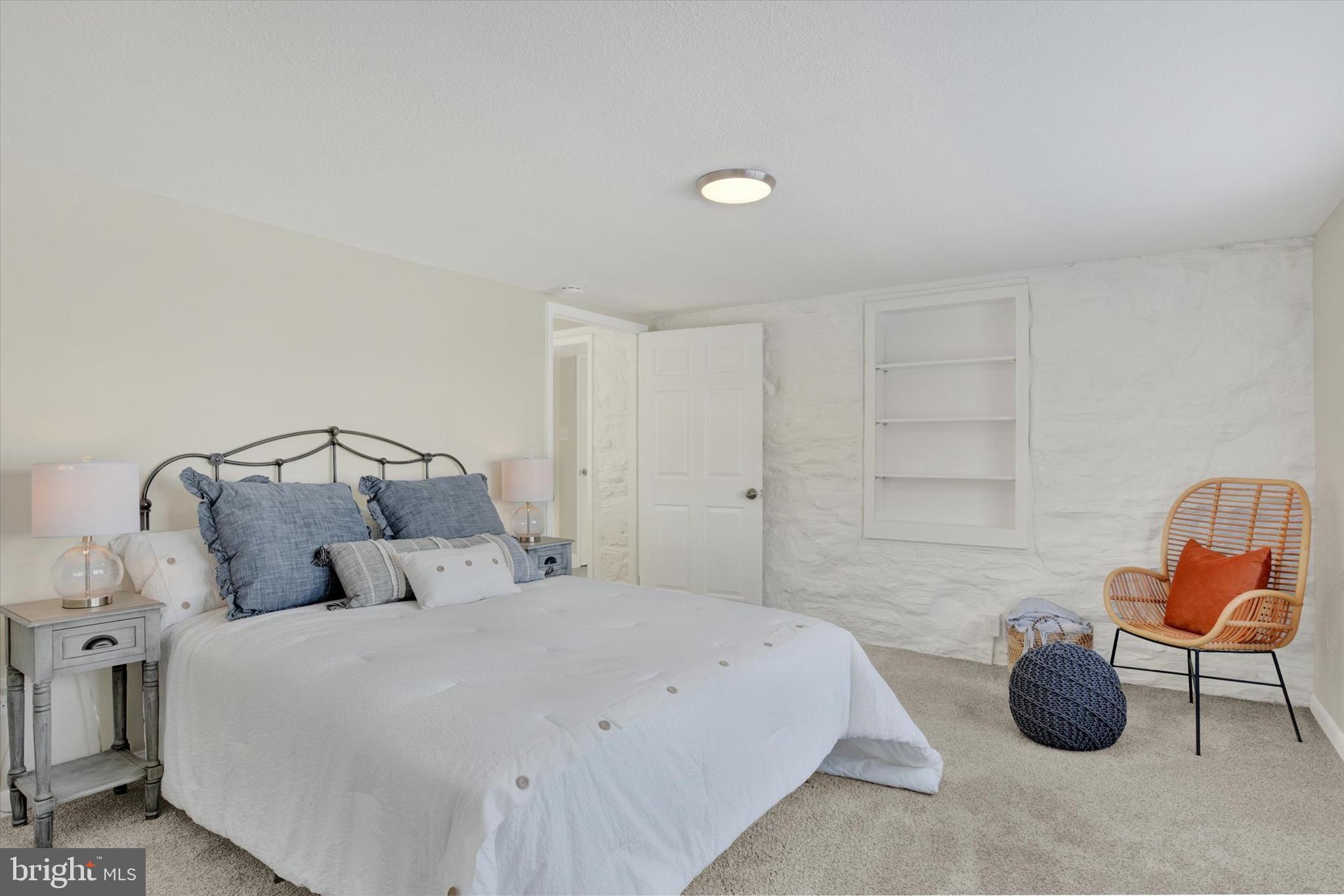 420 Walnut Street East Cleona, PA 17042 - Photo 21 of 30 a bedroom with a bed a chair and potted plant on the dresser