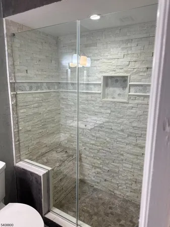 a bathroom with a toilet and a shower