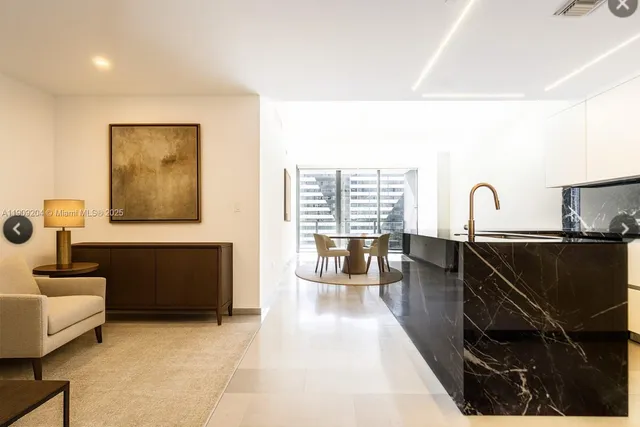 a living room with furniture a flat screen tv and a large window