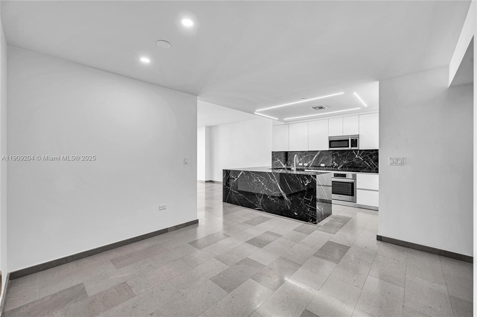 88 Southwest 7th Street, Unit 806 Miami, FL 33130 - Photo 12 of 54 a kitchen with stainless steel appliances a stove and more cabinets