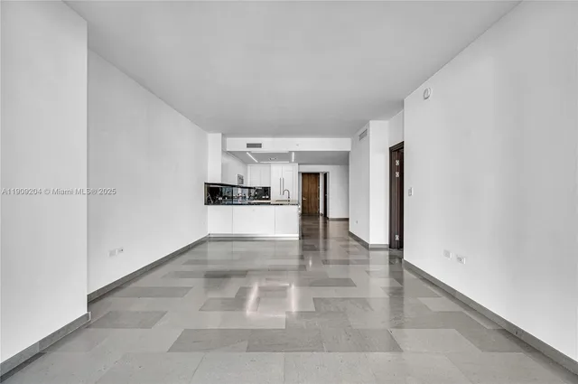 a kitchen with stainless steel appliances a sink and a refrigerator