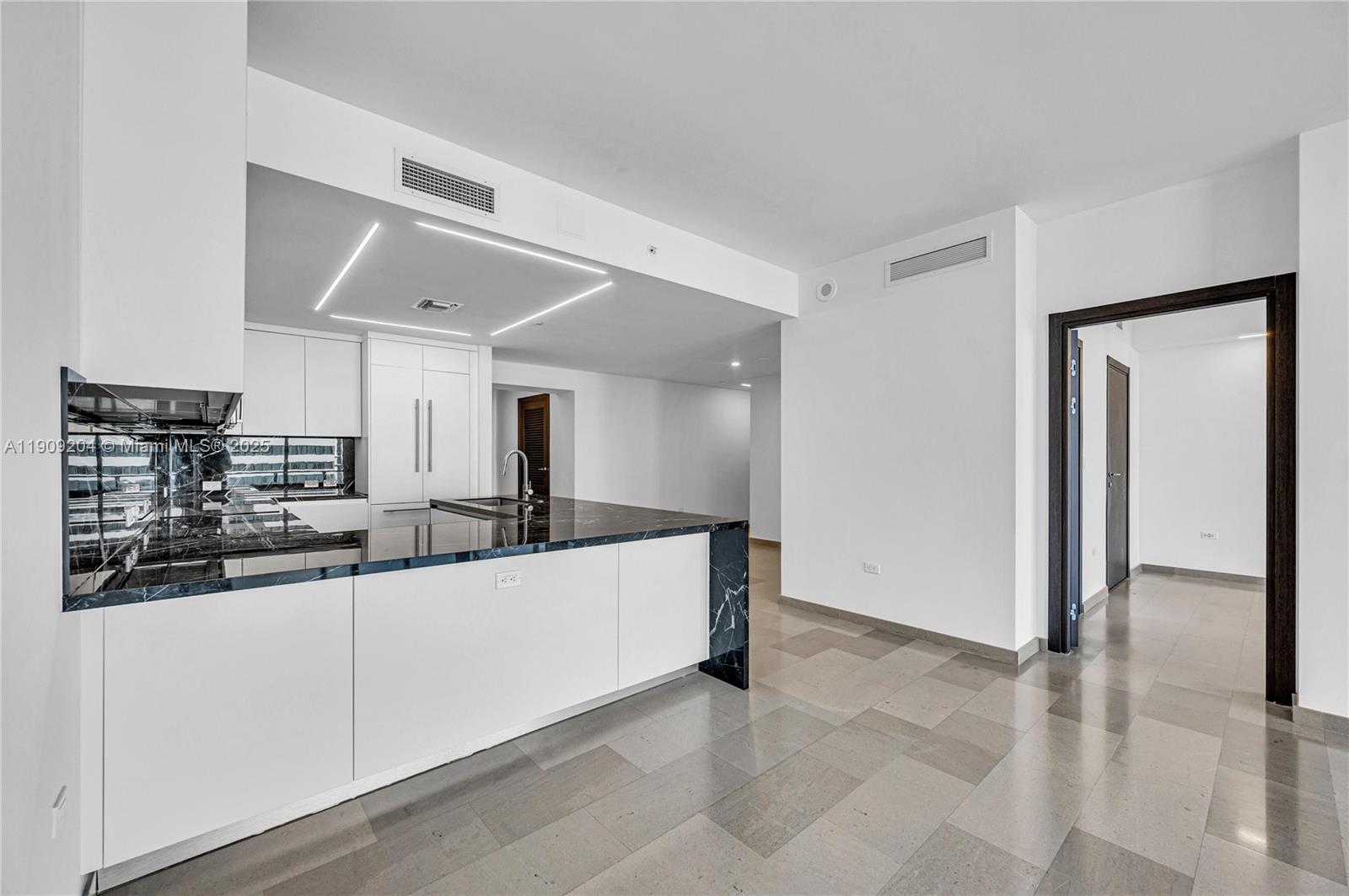 88 Southwest 7th Street, Unit 806 Miami, FL 33130 - Photo 22 of 54 a kitchen with stainless steel appliances a sink and a refrigerator