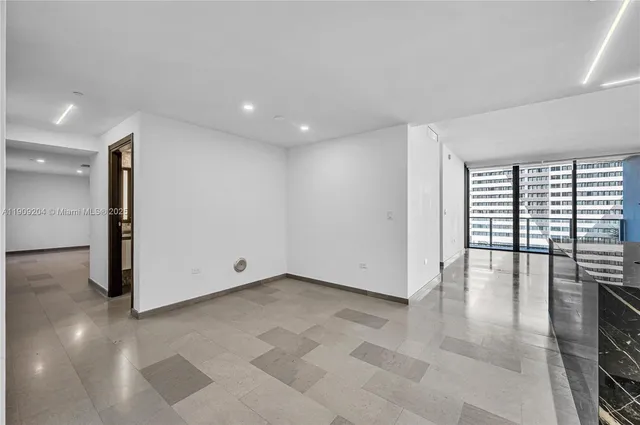 a bathroom with a granite countertop sink a mirror and a shower