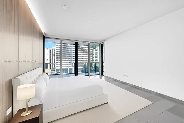 a bathroom with a granite countertop sink and a large mirror