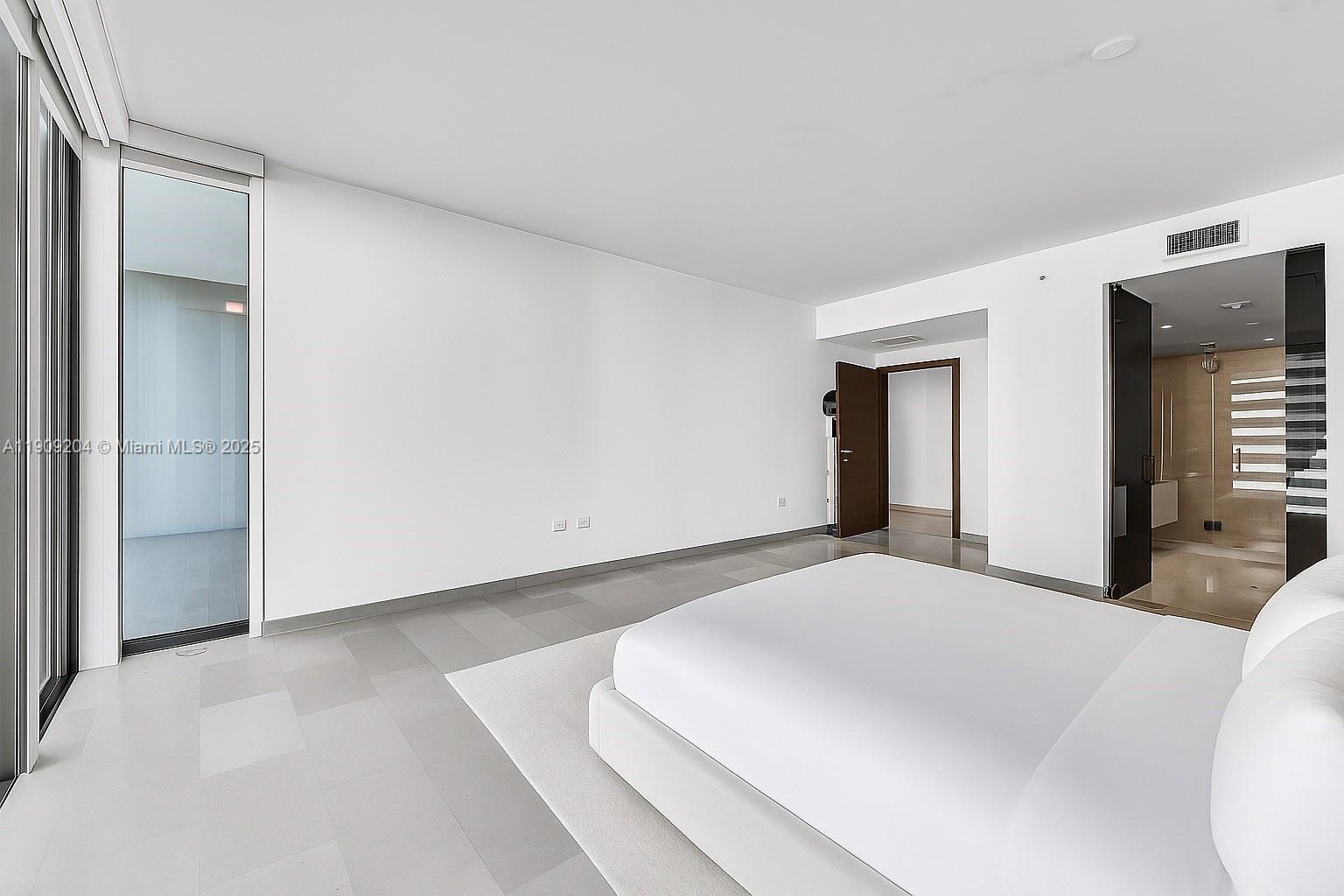 88 Southwest 7th Street, Unit 806 Miami, FL 33130 - Photo 34 of 54 a large white bed in a white room