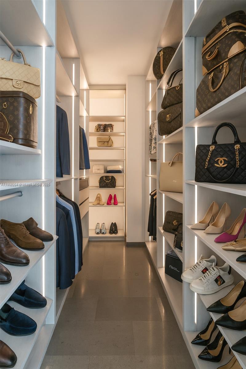 88 Southwest 7th Street, Unit 806 Miami, FL 33130 - Photo 36 of 54 a bedroom with furniture and a closet