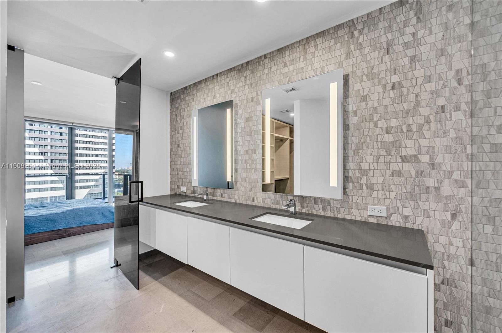 88 Southwest 7th Street, Unit 806 Miami, FL 33130 - Photo 41 of 54 a bathroom with a granite countertop sink and a large mirror