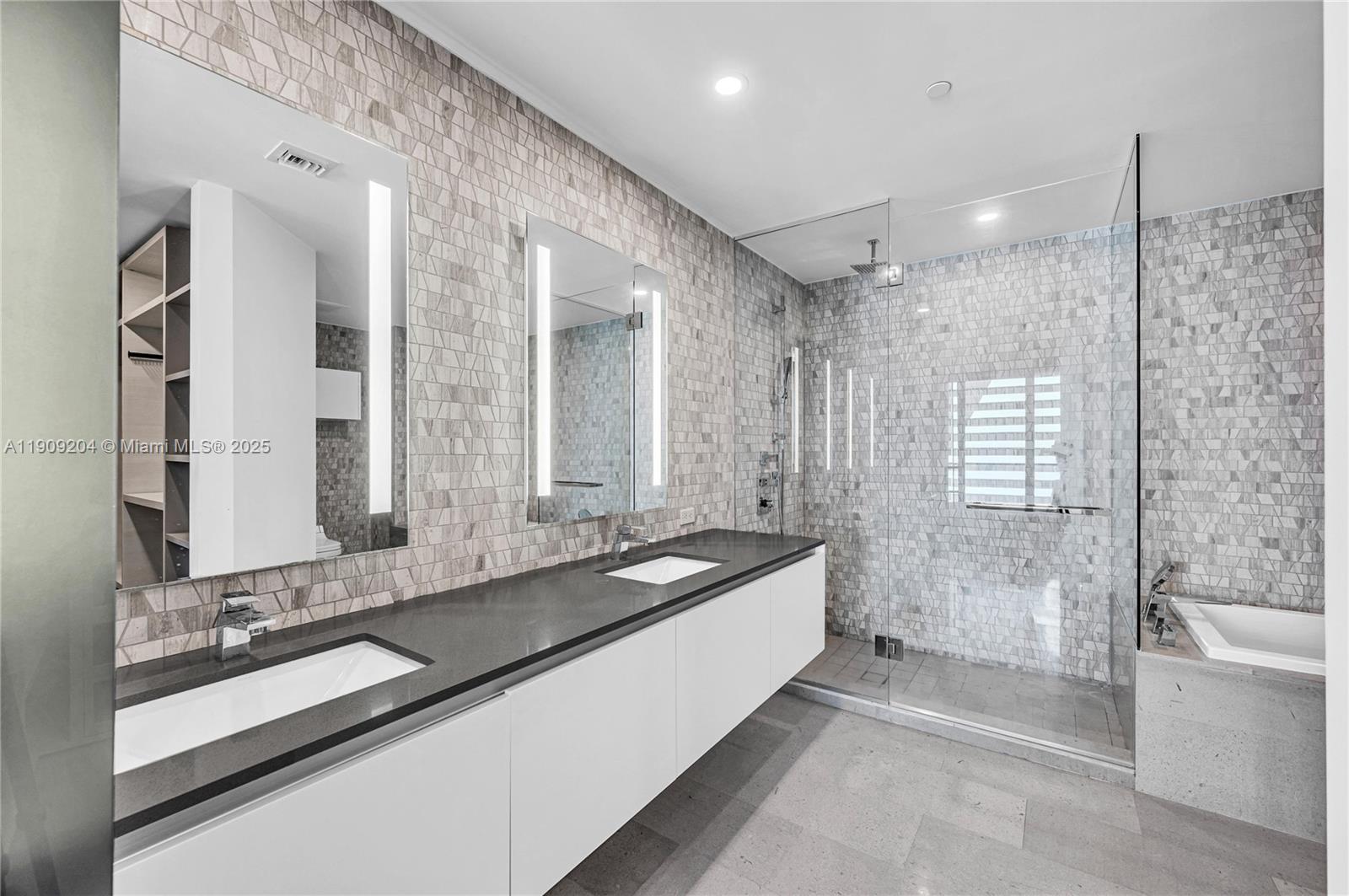 88 Southwest 7th Street, Unit 806 Miami, FL 33130 - Photo 45 of 54 a spacious bathroom with a bathtub shower sink and mirror