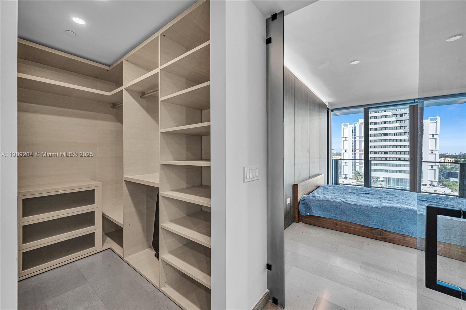 88 Southwest 7th Street, Unit 806 Miami, FL 33130 - Photo 46 of 54 a spacious bedroom with a bed and a window