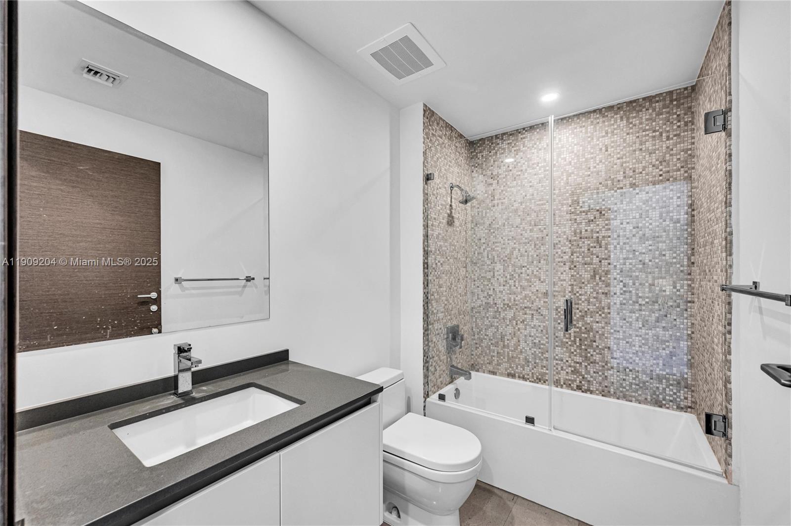 88 Southwest 7th Street, Unit 806 Miami, FL 33130 - Photo 54 of 54 a bathroom with a granite countertop sink toilet and shower